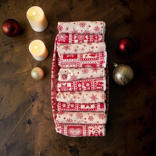Panière de serviettes pour invités Noël montagne vue de dessus Panière de serviettes pour invités Noël montagne, serviettes roulées en coton éponge et coton imprimé, vue de dessus avec bougies et boules rouges - Atelier Julac