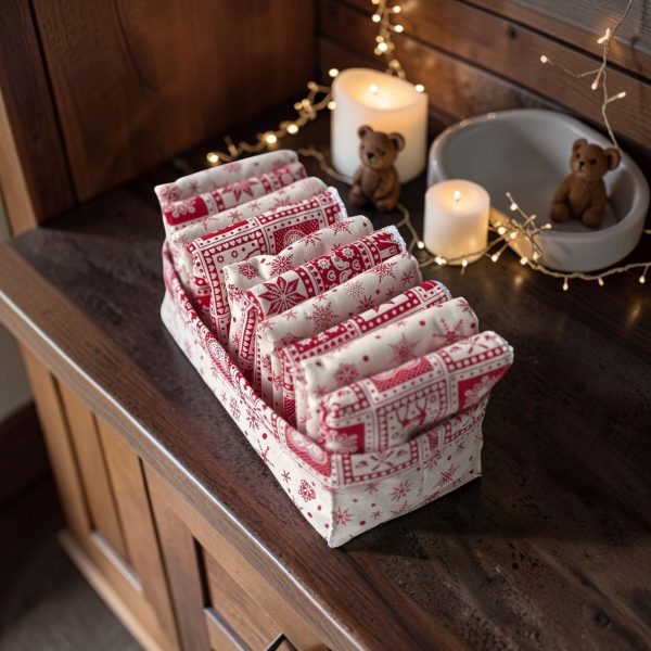 Panière serviettes pour invités Noël montagne vue de profil Panière serviettes invités Noël montagne, serviettes en coton éponge et coton imprimé rangées dans la panière, vue de profil avec guirlandes et bougies - Atelier Julac
